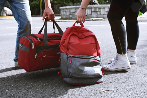 Red backpack and duffle bag carry on