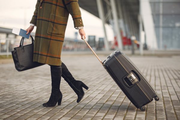 Woman with carry on suitcase and personal item